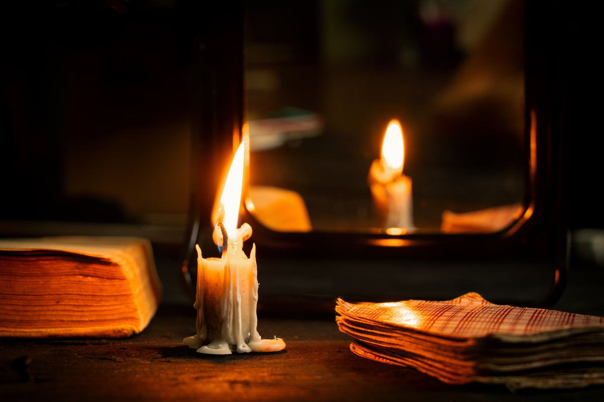 A Burning Candle Was Carried by Mirrors and Fortune-Telling Cards Lie Nearby, Fortune-Telling on Cards by Candlelight on a Black Table, Magic